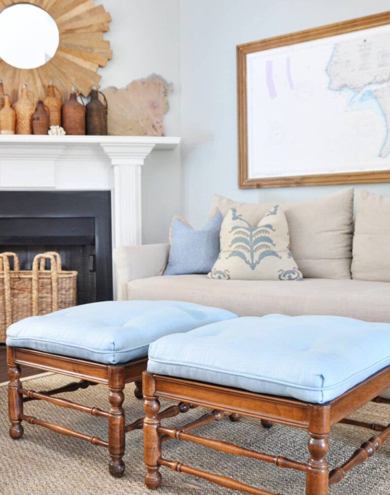 light blue covered twin ottomans in front of a cream colored sofa