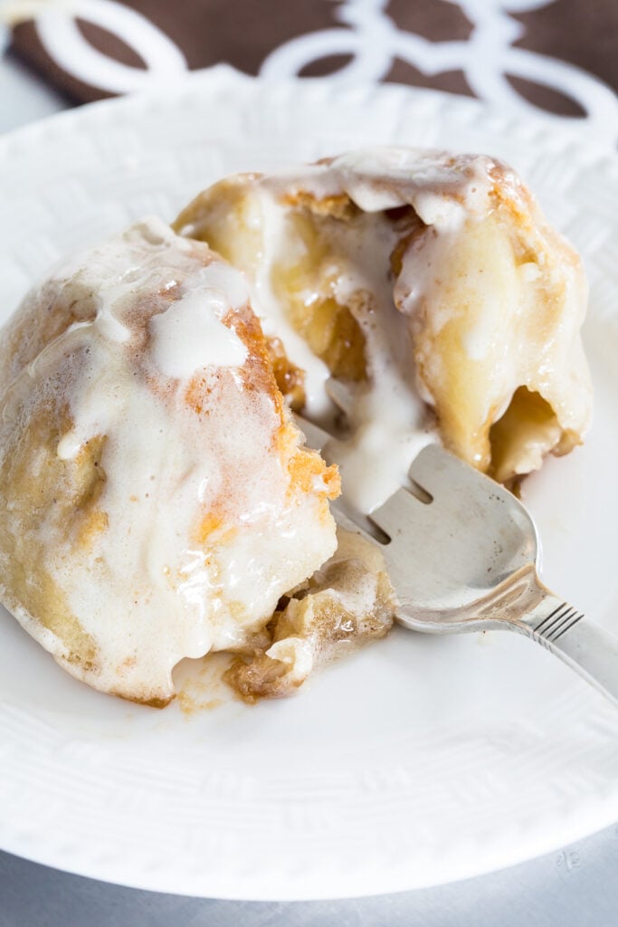 Breaking apart an Apple Cannonball baked apple with a fork