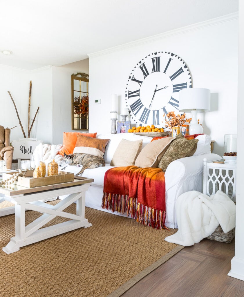 Bloggers Fall home tour living room decorated in fall colors of orange and brown with a navy accent.