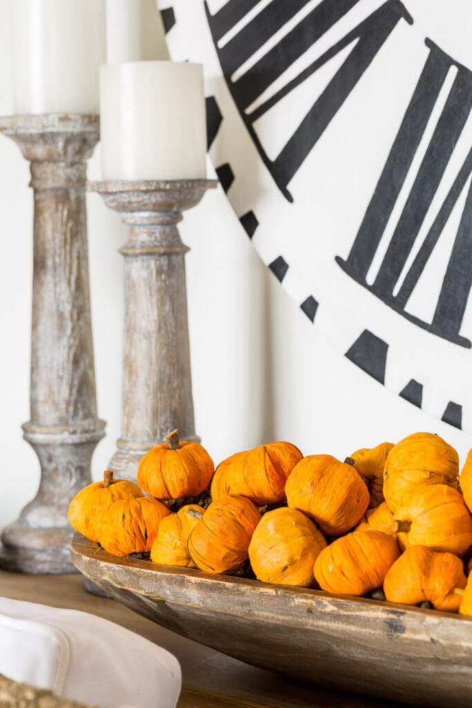 Paper mini pumpkins in a long wood bowl