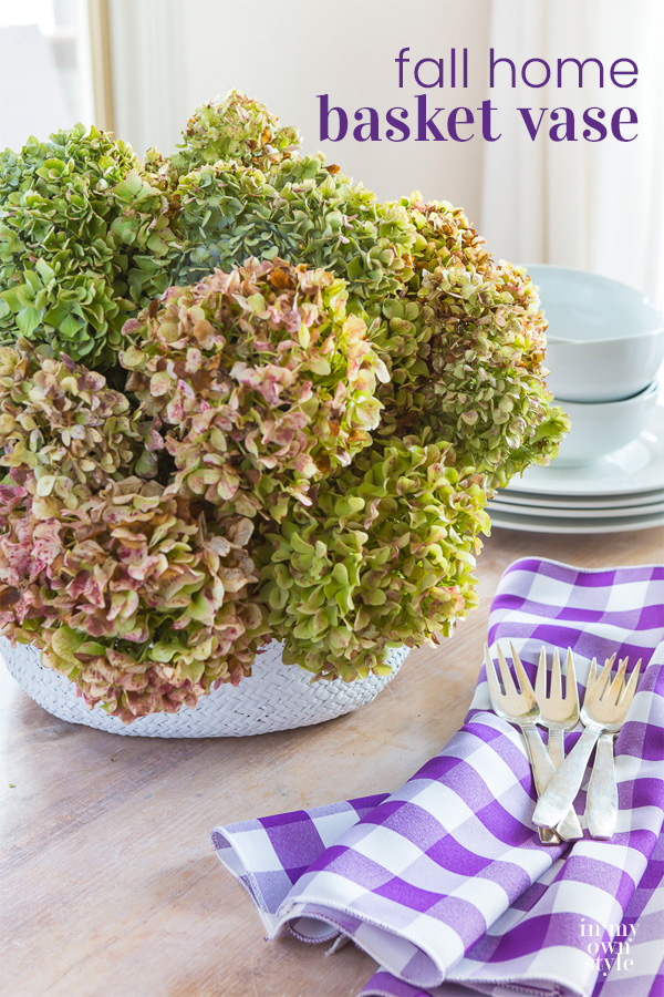 Collapsible Basket on table filled with dried hydrangeas.