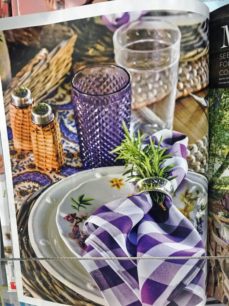 Fall table setting with baskets and purple and white checked napkins