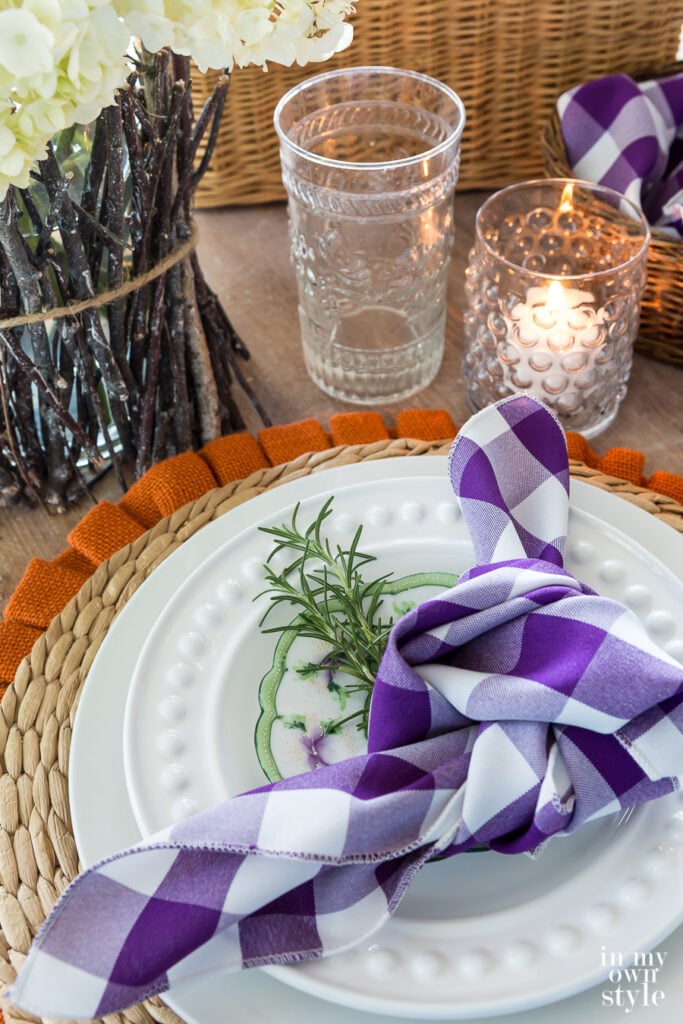 Fall inspired Table setting with purple and white buffalo checked napkin.