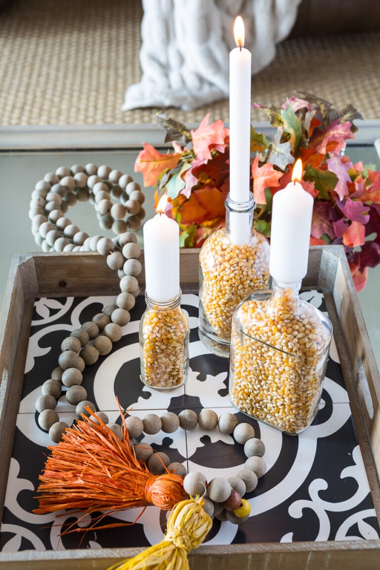 Fall candle holders in a tray on a coffee table