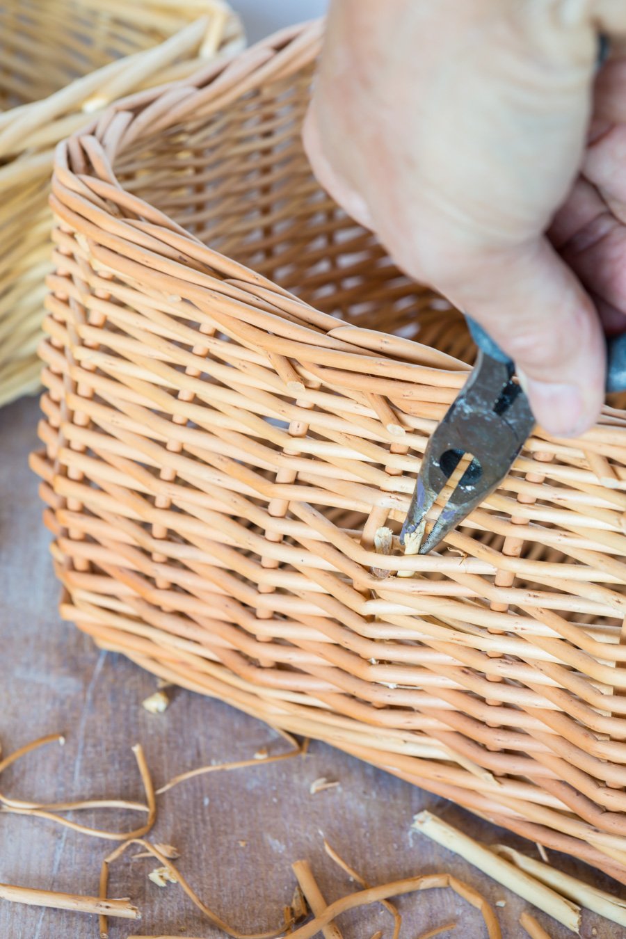 Removing handle and shim reeds on a wicker basket that will be used for cheap, but decorative storage