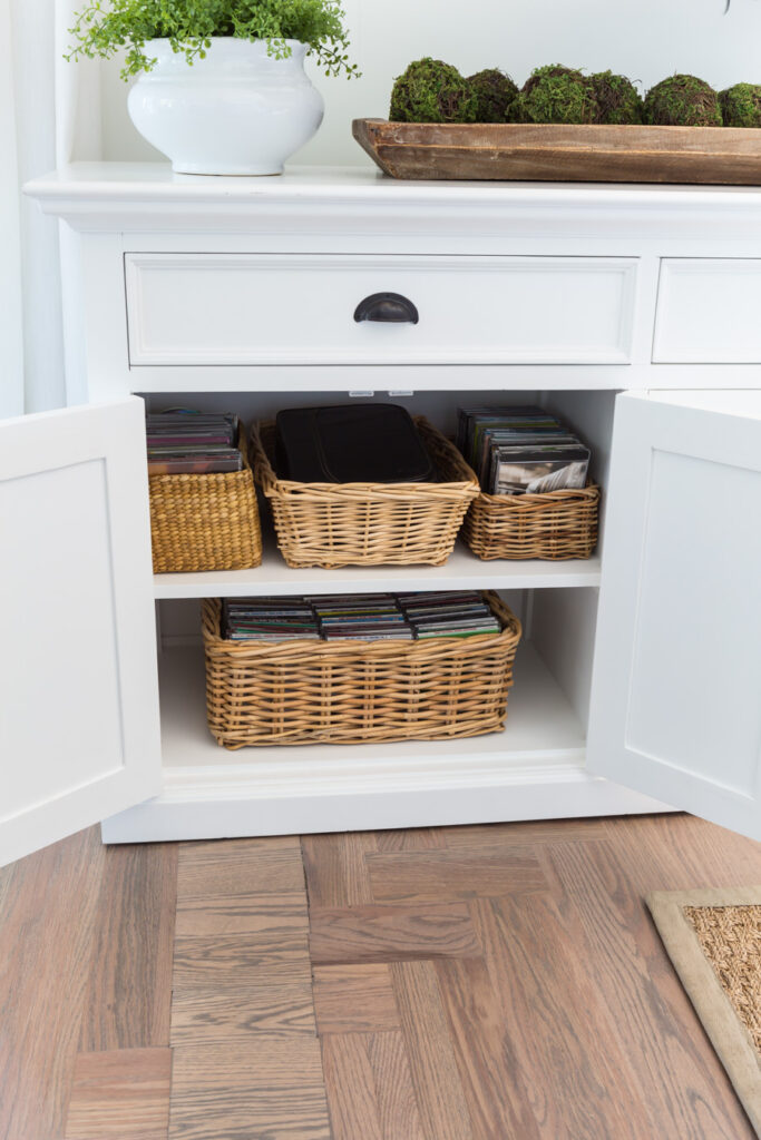 Storage baskets in a sideboard cabinet.