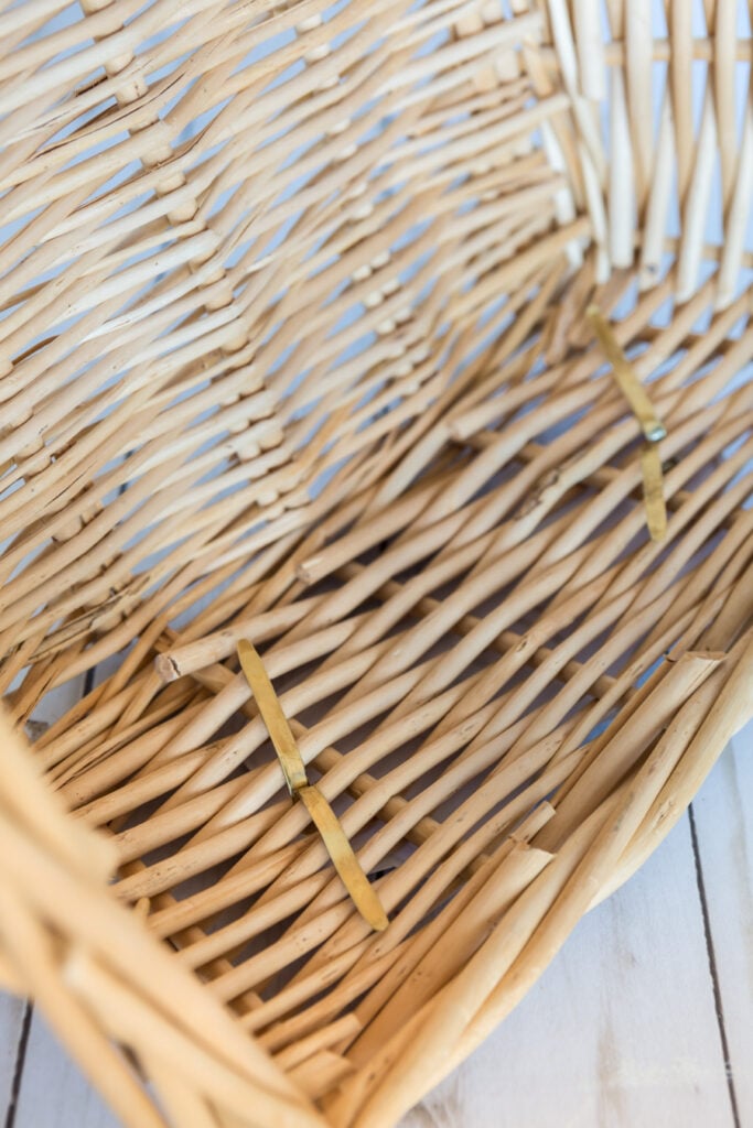 How to attach a label using a brass fastener to a storage basket.