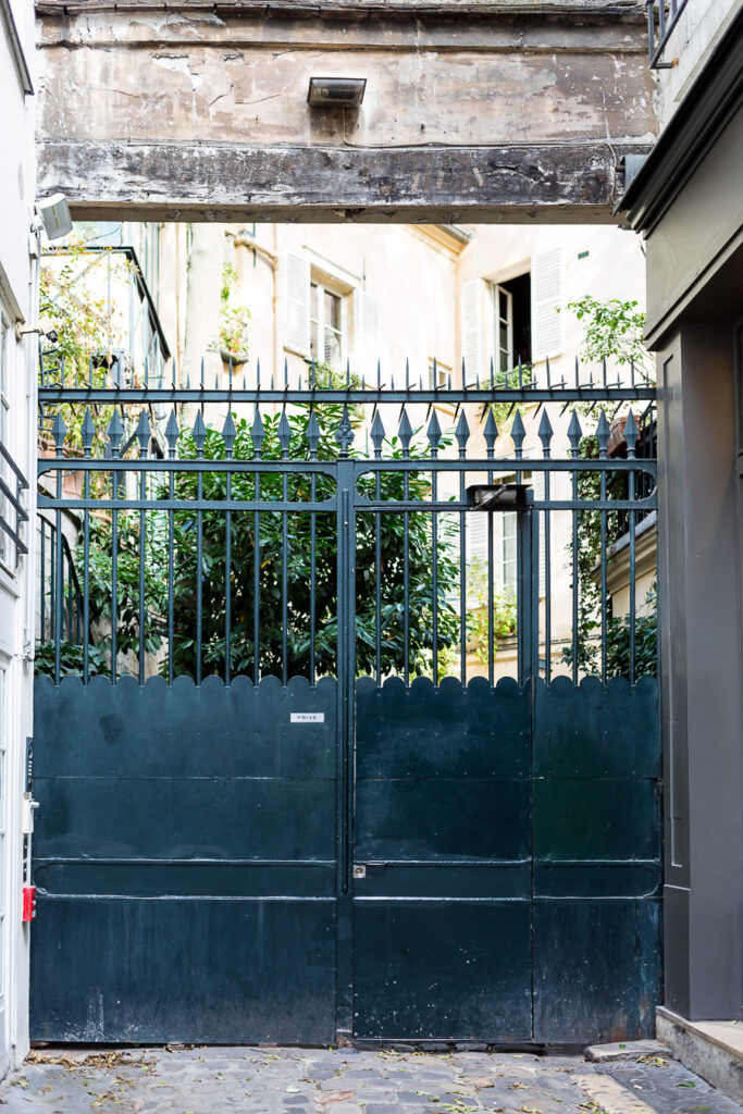 Gate to inner courtyard of an apartment building in Paris.