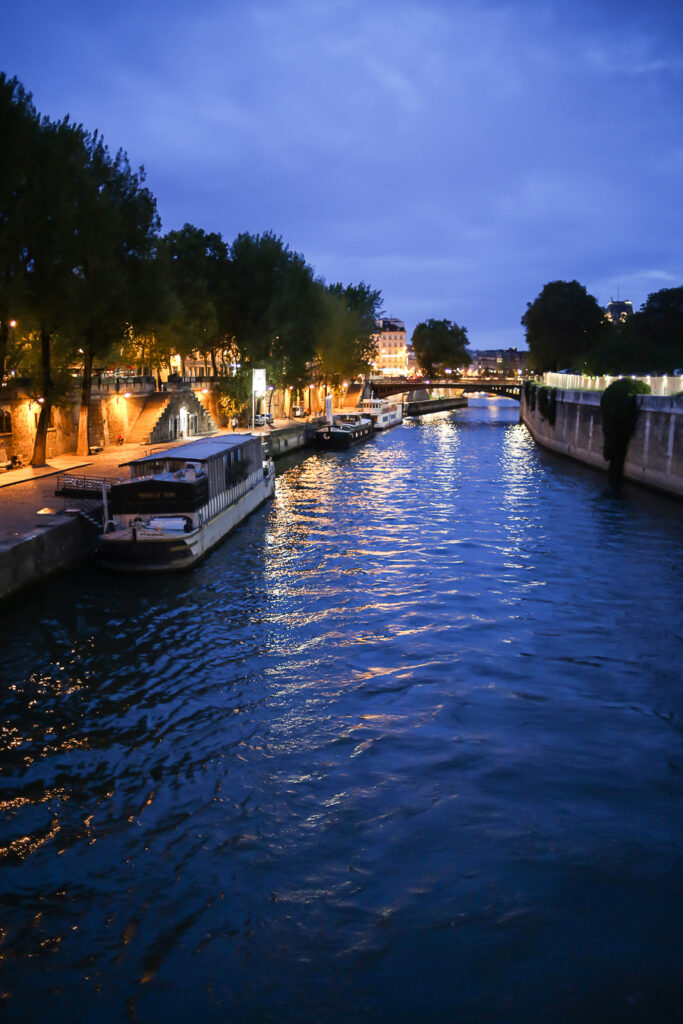Paris Bike Tour at night. Crossing a bridge on a bike over the Seine in Paris at night