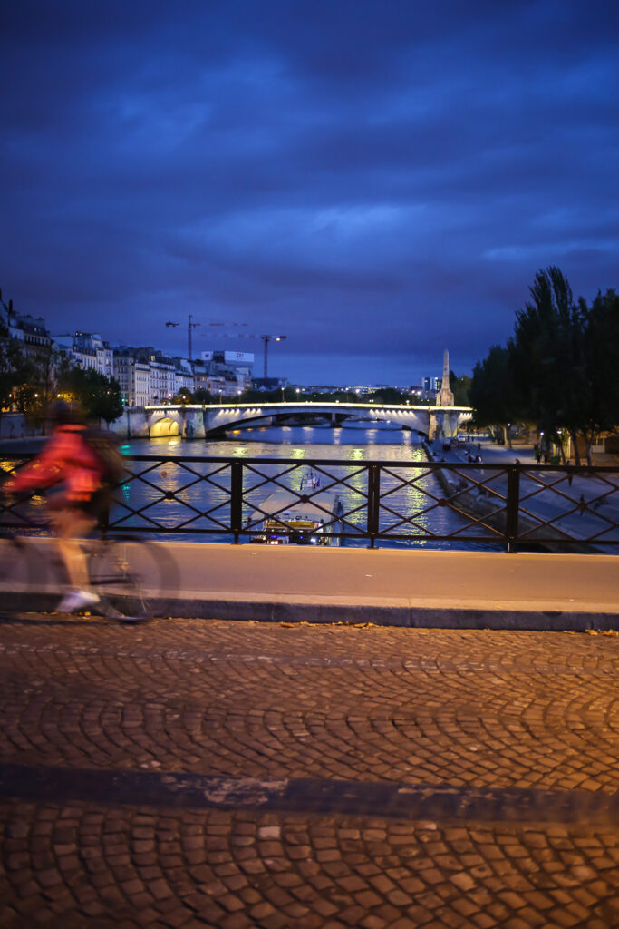 Crossing a bridge on a bike tour over the Seine in Paris at night