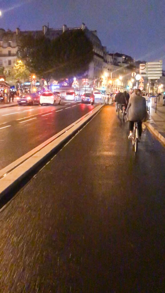 Riding bikes at night in Paris along the bike path in St. Germain.