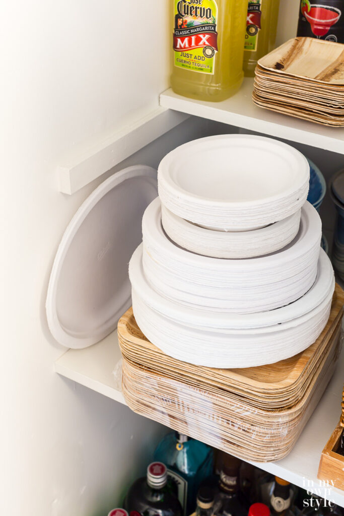 White paper plates stacked in entertaining supply closet.