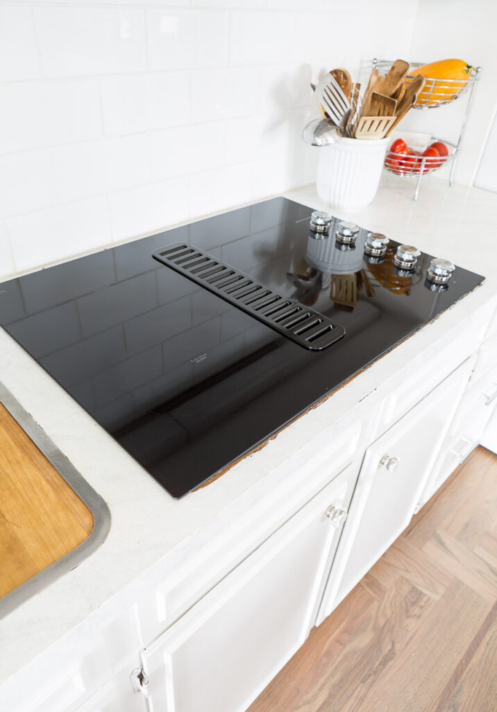 new black glass ceramic drop in cooktop in kitchen.