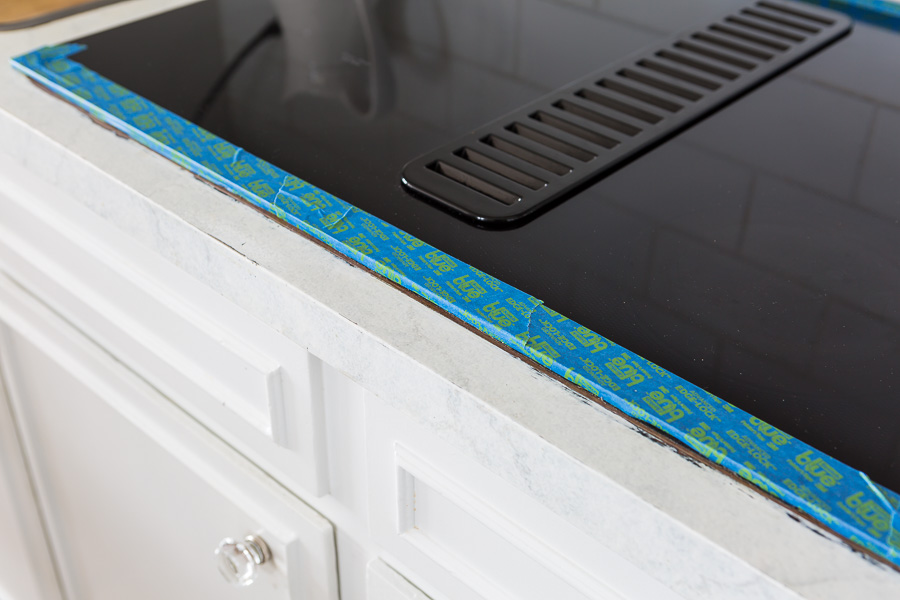 Picture of painted kitchen counter getting repaired.