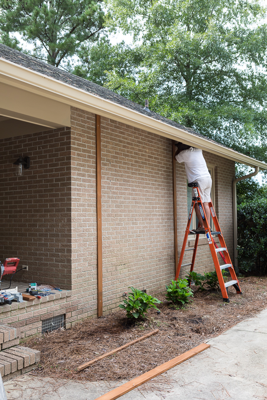 How to attach vertical wood boards to a brick wall to create a wood feature wall outdoor