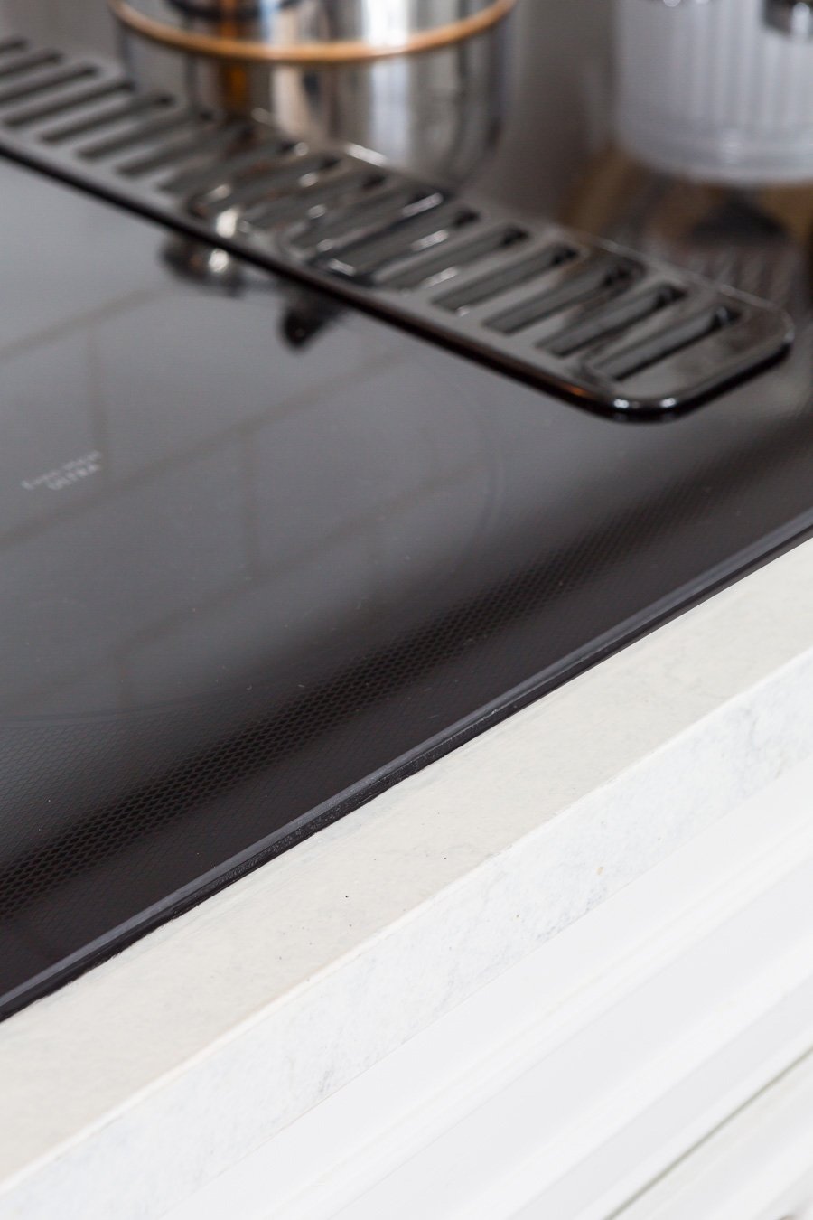 Kitchen-Black-glass-cooktop in white kitchen