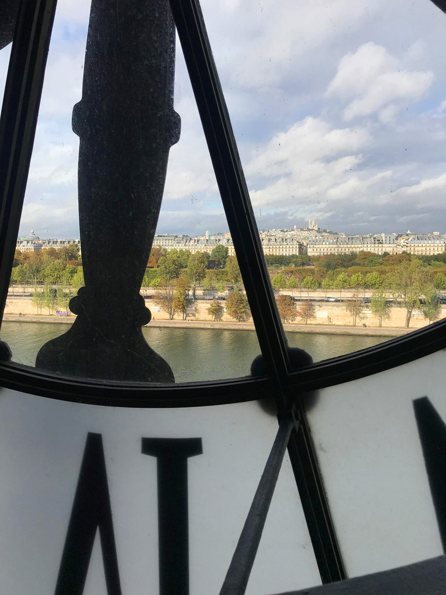 Looking through the large Roman numeral clock at the Museum D'Orsay in Paris.