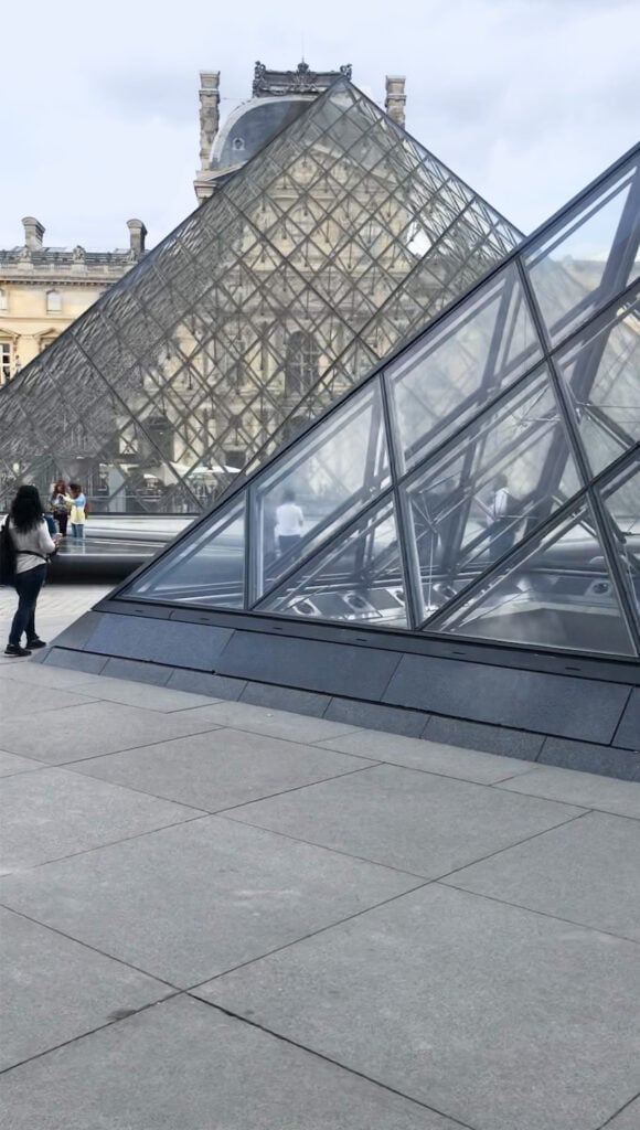 Bike tours in Paris that take you to the courtyard of the Louvre in Paris France to see the glass pyramids.
