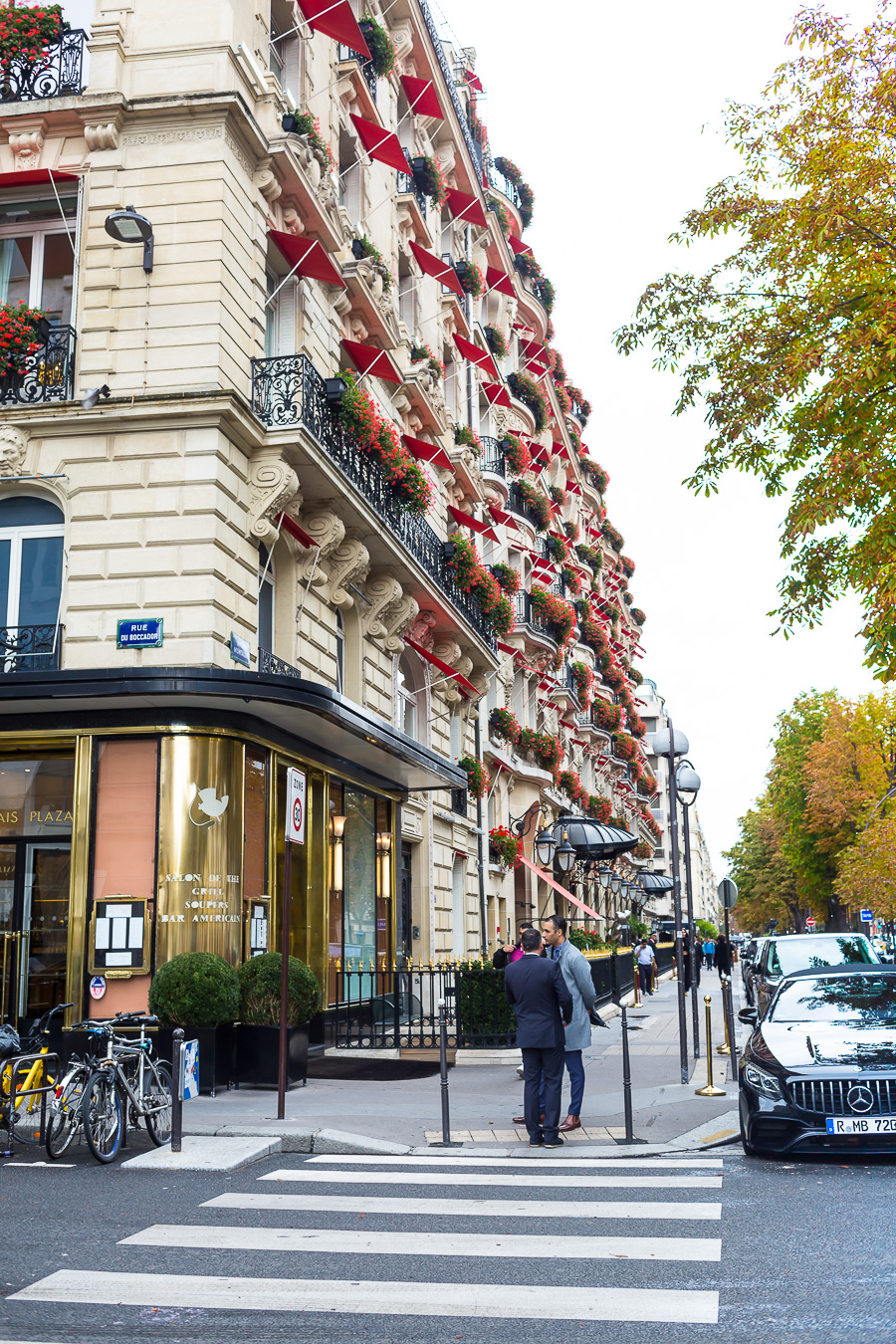 Paris apartment building with red awnings.