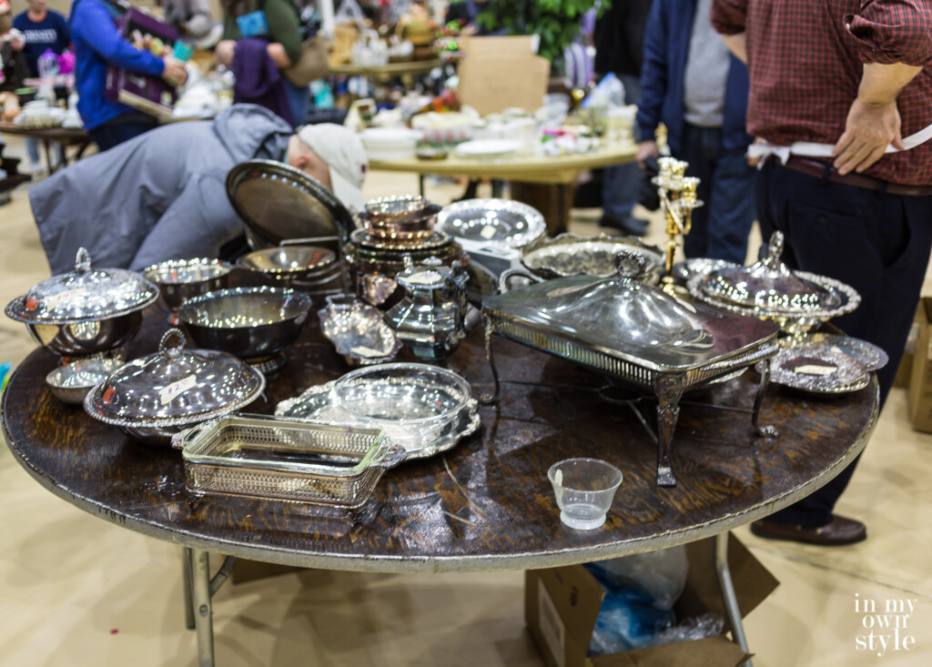 Silver and silver plate items on a sale table