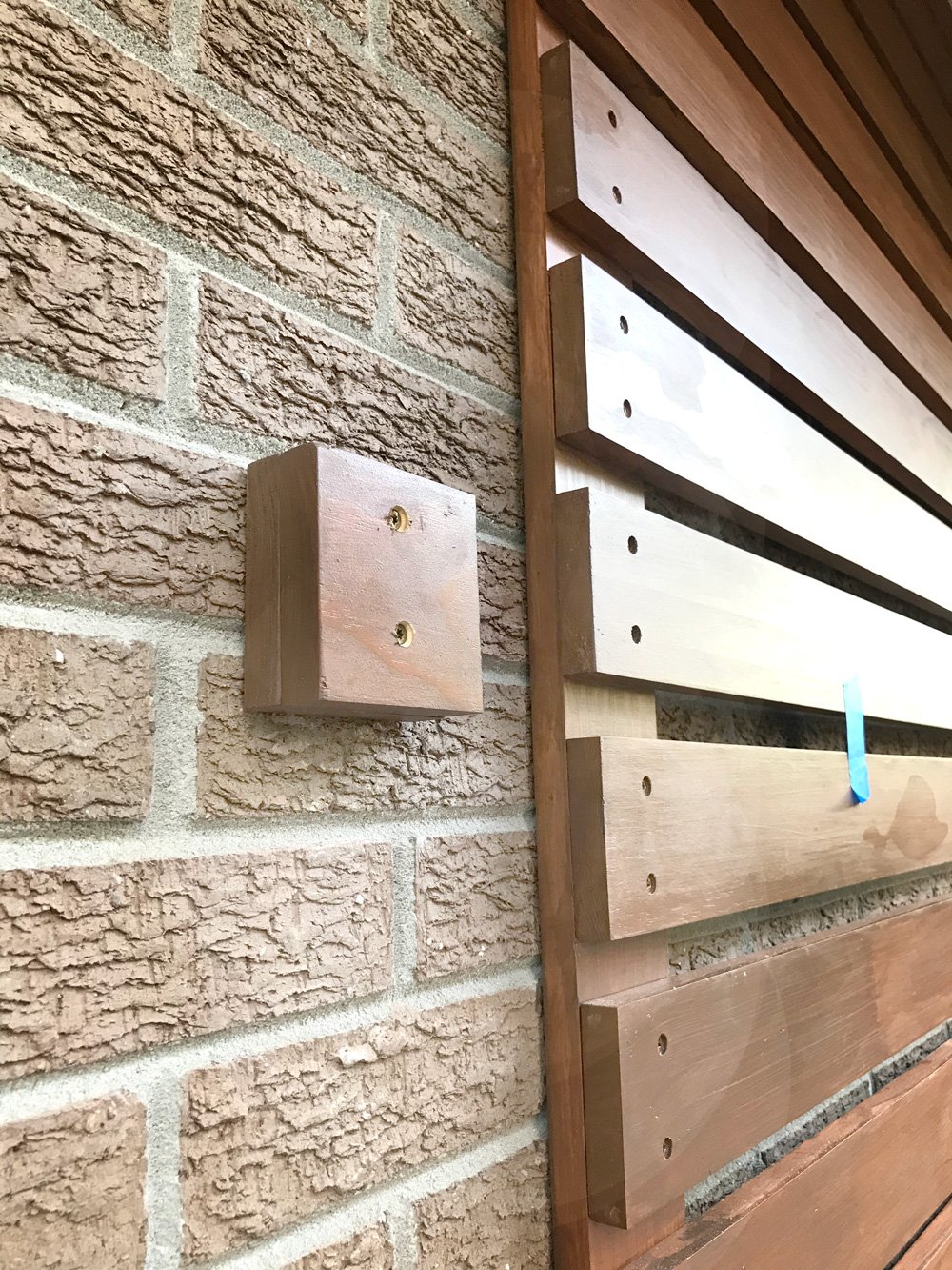 mounting-an-address-plate-on-brick-wall