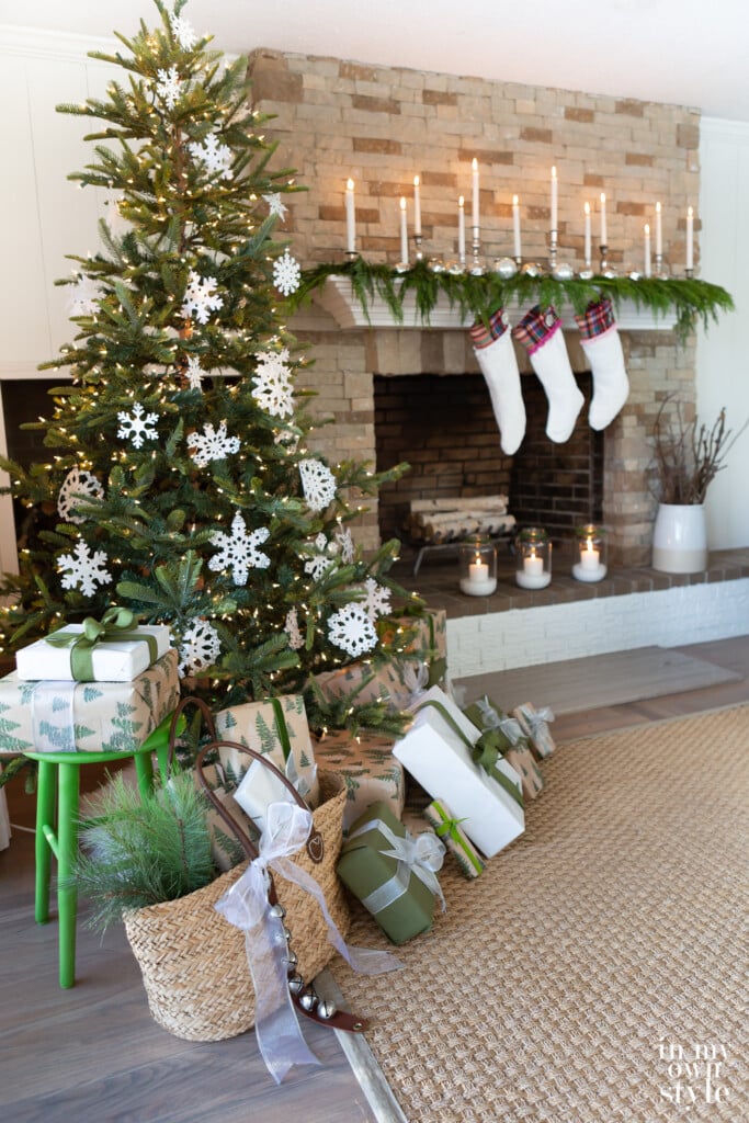 Living room with stone fireplace and seagrass rug decorated for Christmas