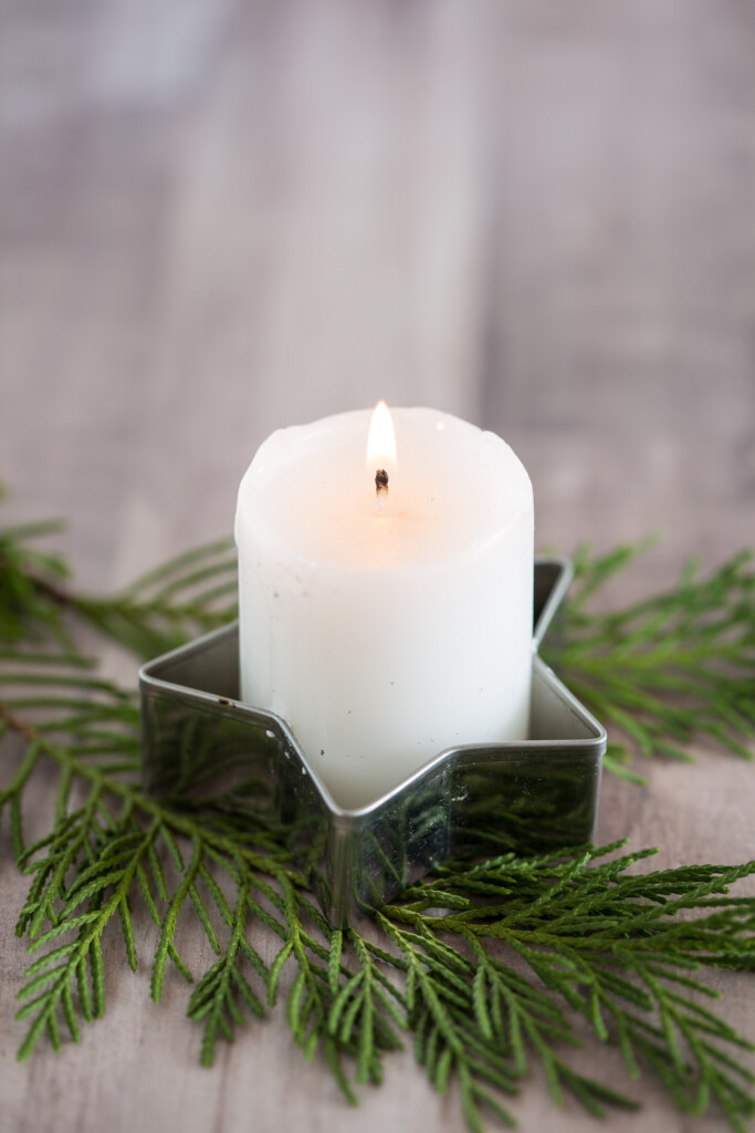 A votive candle placed inside a metal cookie cutter makes for fast and easy Christmas decor