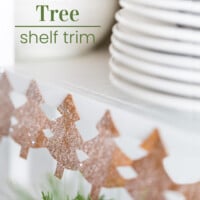Christmas Tree paper chain along edge of open shelves in a kitchen.