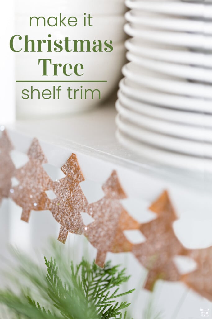 Christmas Tree paper chain along edge of open shelves in a kitchen.