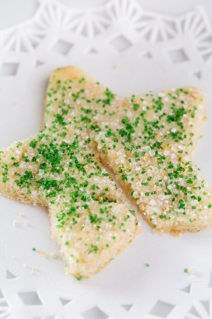 Star shaped Christmas sugar cookie  with green and white sprinkles on top.