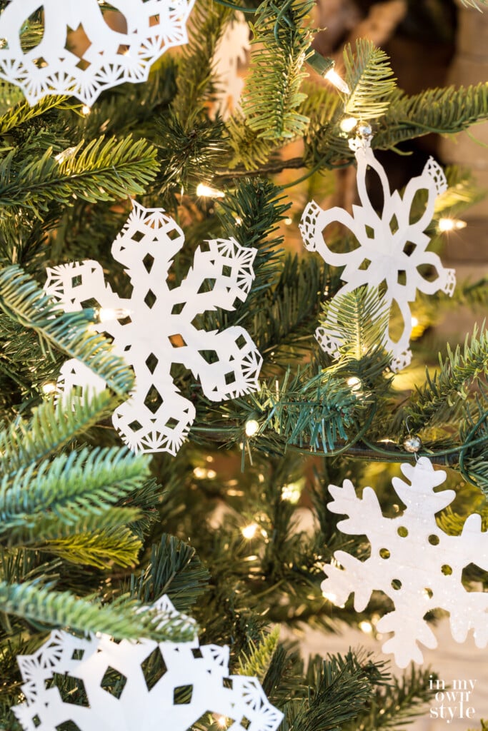 Paper Snowflakes hanging on a Christmas tree made using paper doilies
