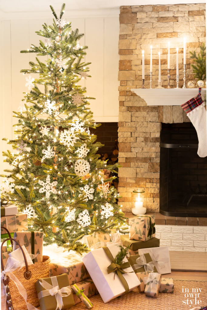 Christmas tree with white lights decorated with handmade paper doily snowflakes