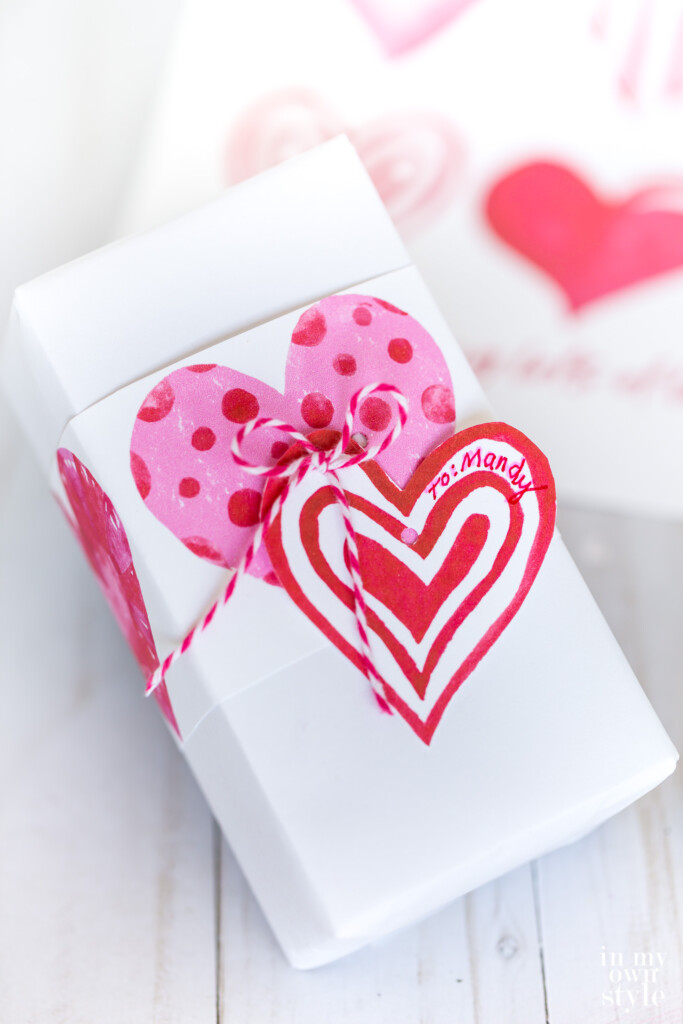 Valentine gift wrapping idea using a sheet of free printable watercolor hearts.