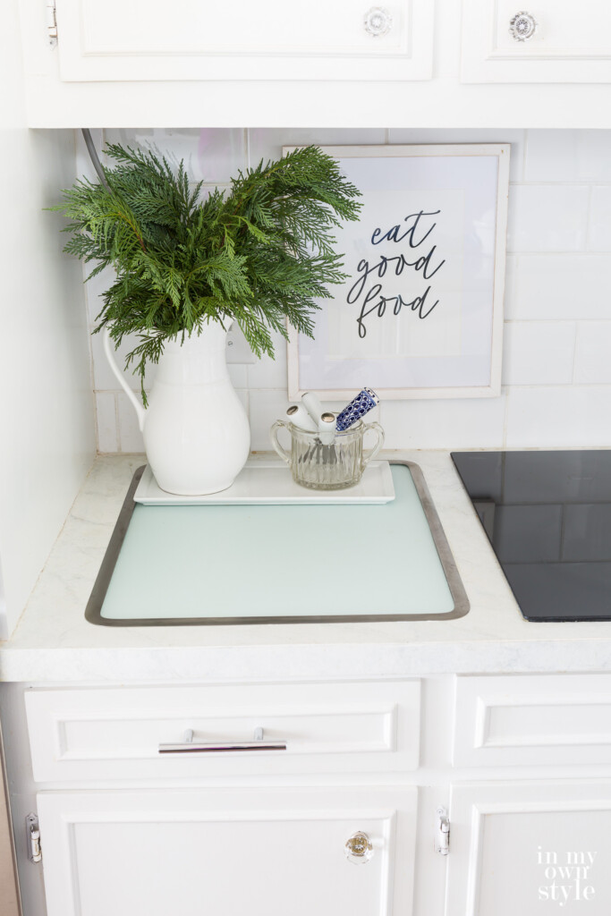 Vance Industries Surface Saver in counter glass cutting board. Framed art on wall says eat good food.