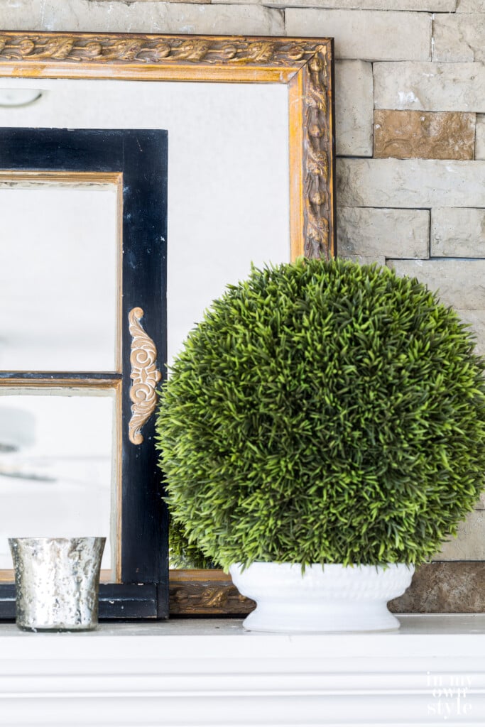 White painted mantel with classic decor on top.