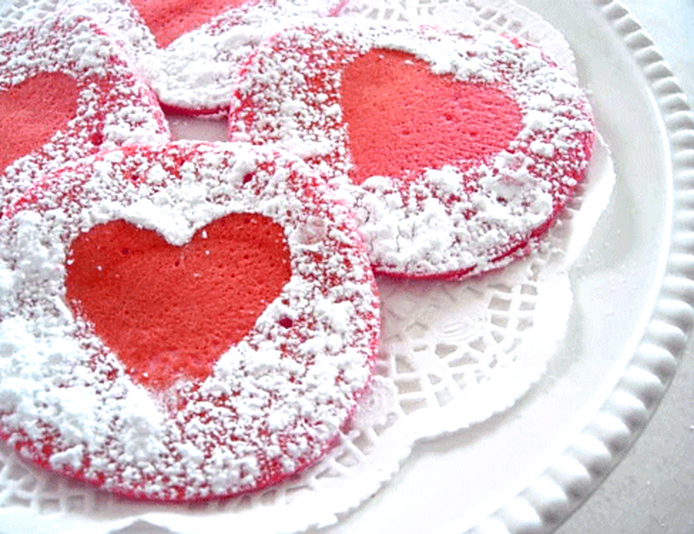Red pancakes with powdered sugar sprinkled over them for Valentine's day or wedding breakfasts.