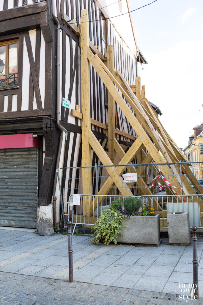 Wood braces in place to secure a 16th century Tudor style building.