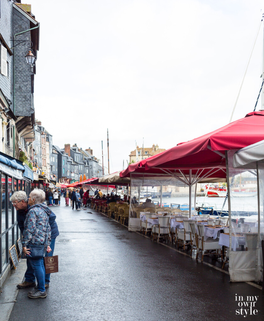 Outdoor cafes in the rain in Honfleur on the coast of Normandy