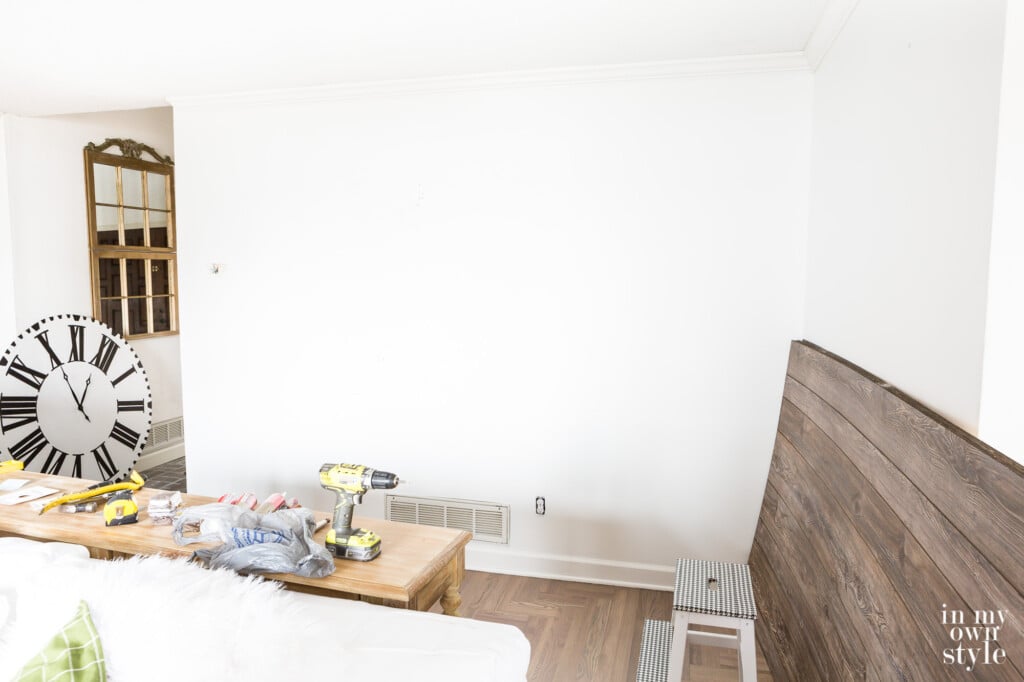 Living room wall before adding barnwood grey vertical sheet paneling to accent wall.