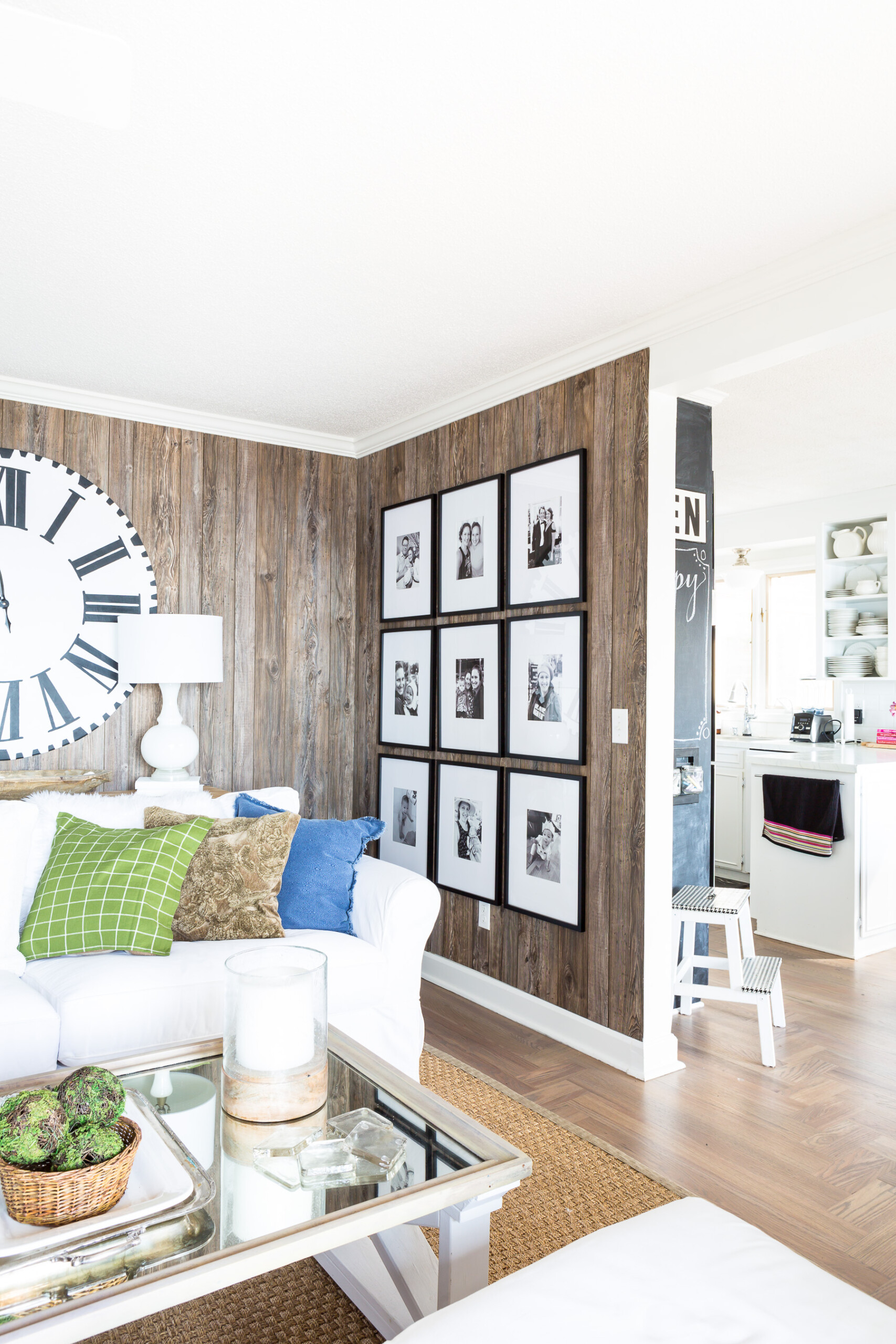 Living room wall with a 9 grid black and white photo gallery wall.