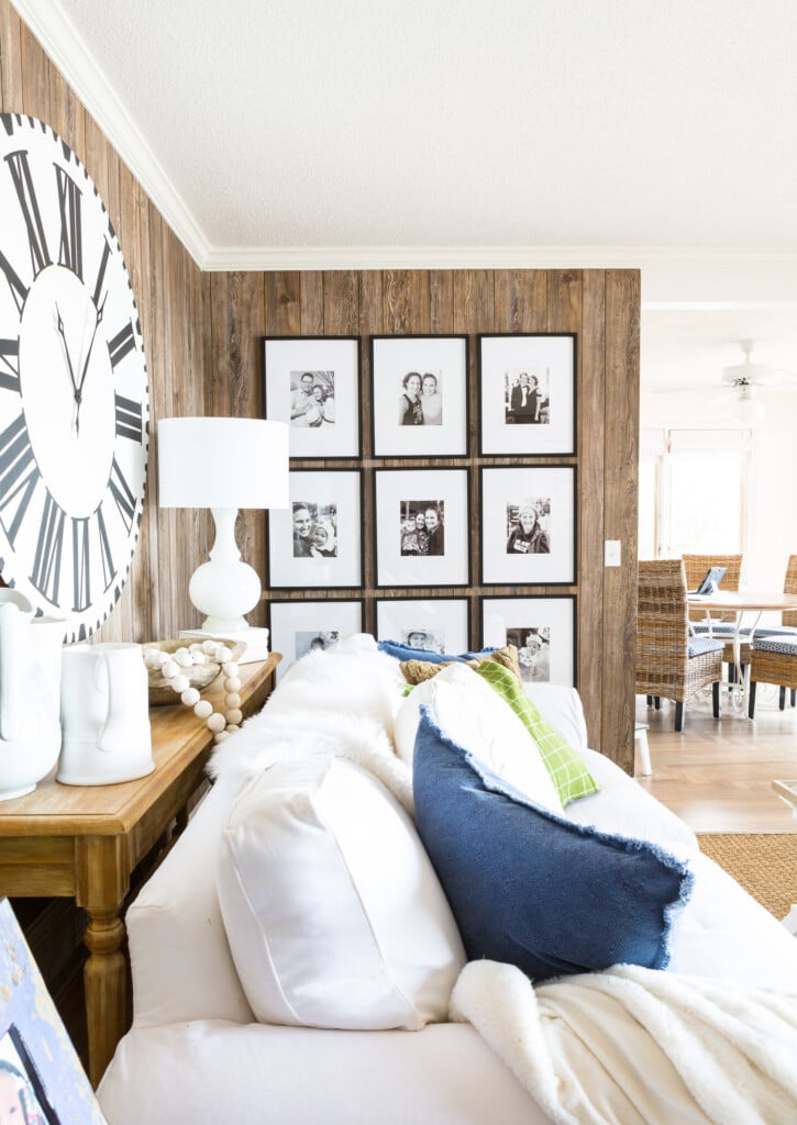 Living room wall with a 9 grid black and white photo gallery wall.