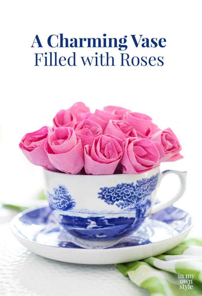 Pink paper napkins made into a dozen roses and placed in a teacup.