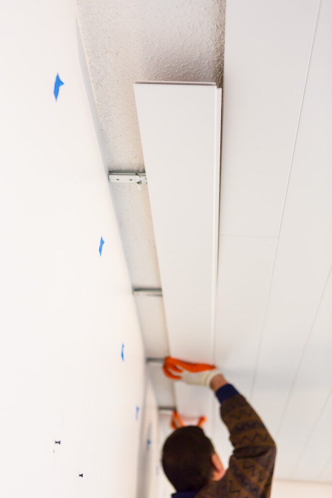Painted White Armstrong WoodHaven  Planks covering a popcorn ceiling. 