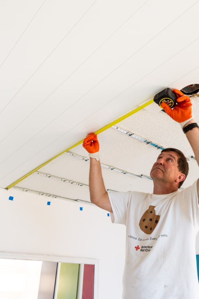 Ideas for covering up a popcorn ceiling with wood planks.