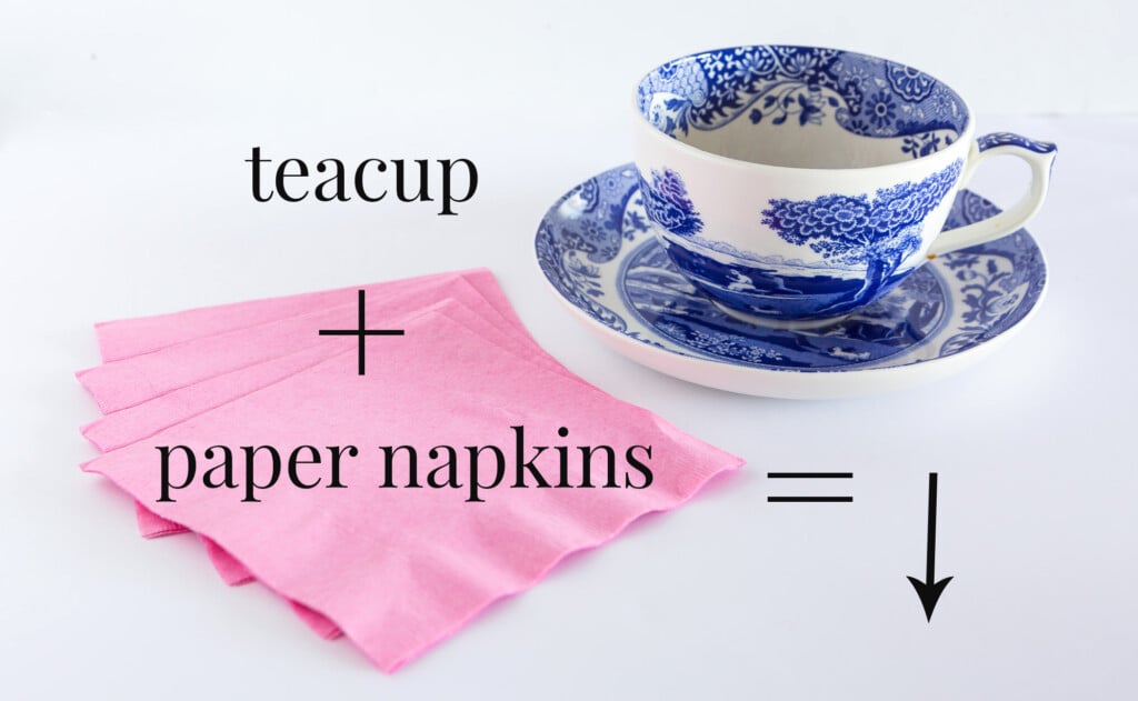 A pile of pink paper napkins and a blue and white china teacup.