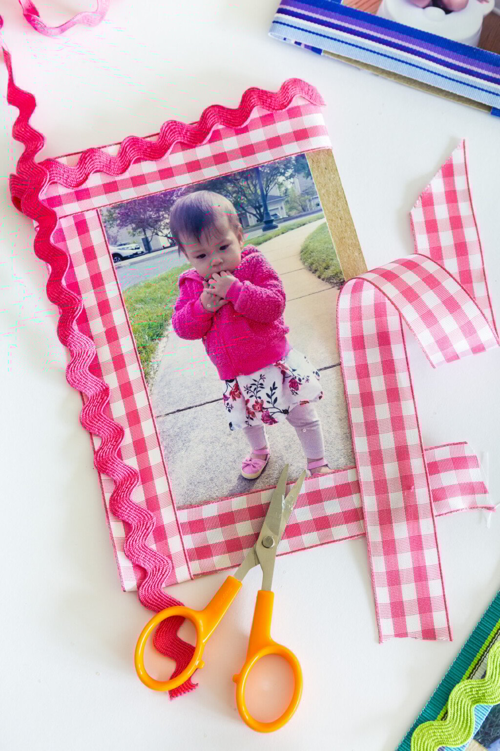 Pink and white gingham ribbon made into a photo frame mat for a small picture frame.