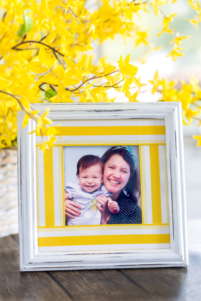 White picture frame with yellow stripe ribbon scrap picture frame mat. Two smiling girls. 