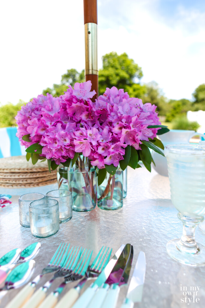 DIY glass bottle vase to go around an umbrella hole and pole on a patio table