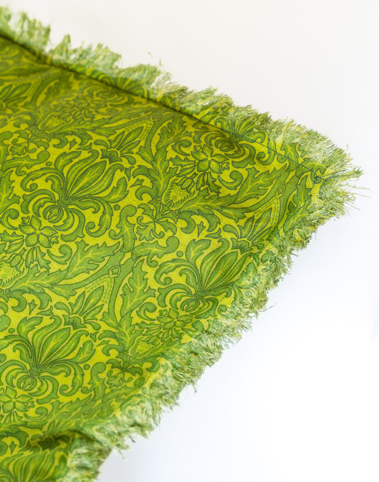 How to fringe cut fabric to make a pretty fringed edge pillow cover.