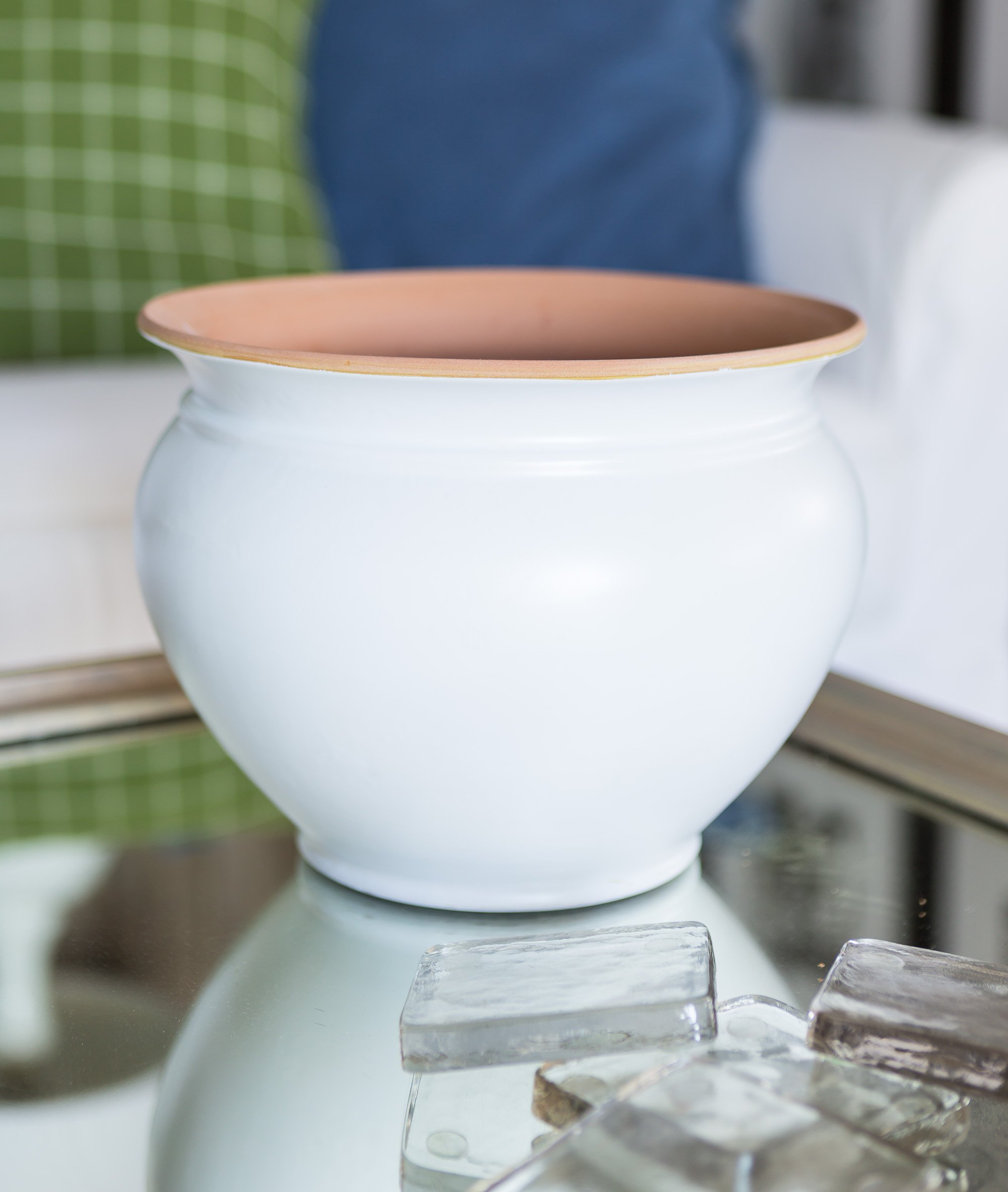 Smooth white spray painted finish on a terra cotta planter.